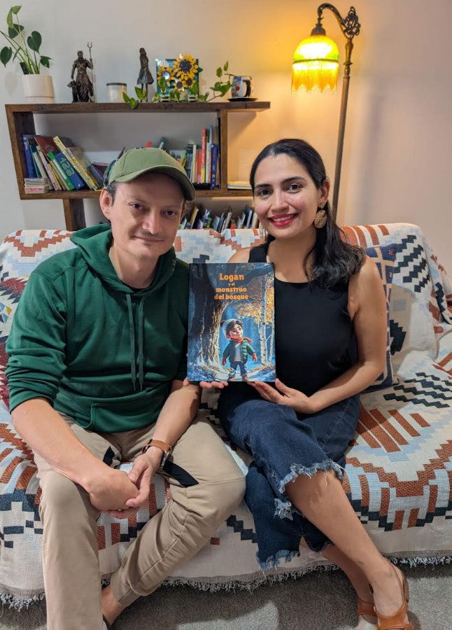 Alba and Camilo, the founders of Bandigon, at home holding one of their books